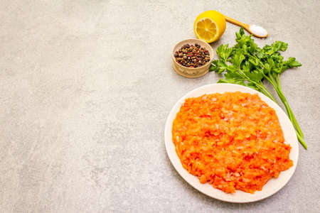 Raw minced red fish (stuffing) on a stone background. Ingredient for making fish-balls, casseroles, terrine, pate. Spices, salt, parsley, lemon. On a stone background, copy spaceの写真素材