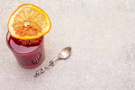 Natural fresh organic smoothies made of viburnum and grapefruit. In a glass on a stone background