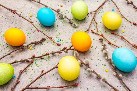 Easter eggs concept willow seals branches, sweet topping on a stone background wallpaper
