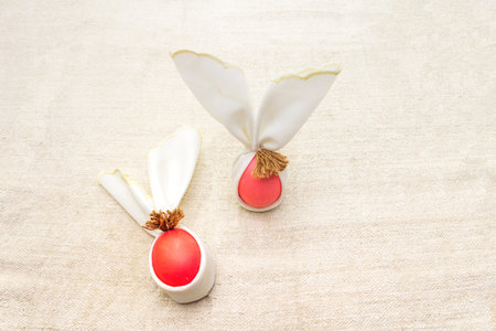 Easter bunny (rabbit) egg concept, table arrangement decoration. Pink (rosy) eggs on cloth vintage...