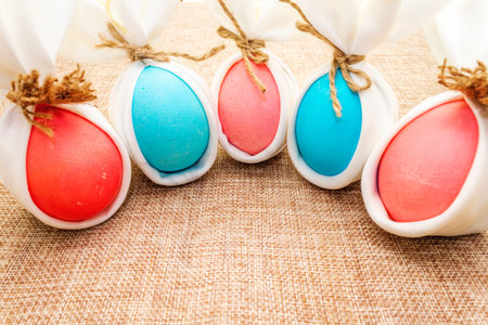 Easter bunny (rabbit) egg concept, table arrangement decoration. Pink (rosy) and blue eggs with...