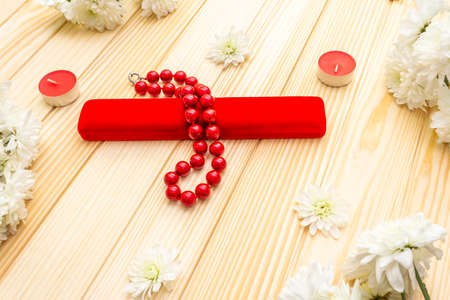 Romantic gift concept. Valentines day or 8th march or love holiday. Present case and flowers. Table setting on wooden background.の写真素材