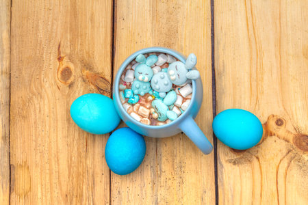 Easter kids hot sweet chocolate or cocoa with funny marshmallow bunny rabbits and easter eggs. On...