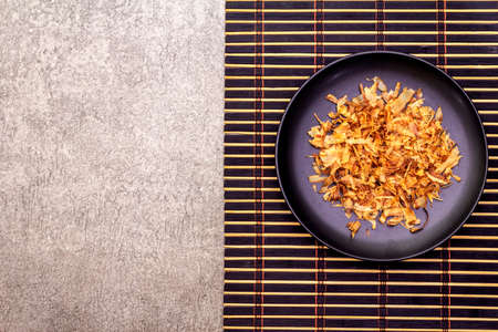 Tuna shaving katsuobushi, bonito flakes, ingredient of japanese soup dashi. On black plate and...