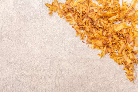 Tuna shaving katsuobushi, bonito flakes, ingredient of japanese soup dashi. On stone background, top...
