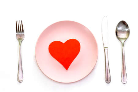 Valentines day (or wedding) set with fork, spoon and knife, paper heart on white background, top view.の写真素材