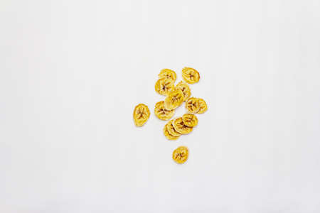 Dried slices of banana isolated on white background. Healthy eating concept, copy space, top viewの写真素材