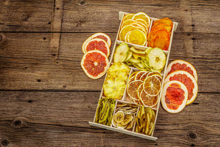 Assorted dried fruits. Healthy eating concept. Wooden box, old boards background, copy spaceの写真素材