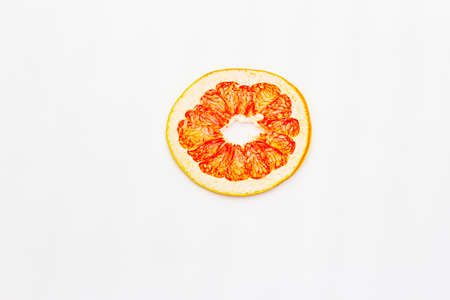 Dried single slice of grapefruit isolated on white background. Healthy eating concept, top view, copy spaceの写真素材