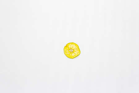 Dried single slice of apple isolated on white background. Healthy eating concept, copy space, top viewの写真素材