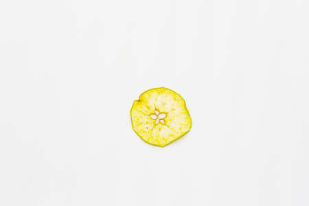 Dried single slice of apple isolated on white background. Healthy eating concept, copy space, top viewの写真素材