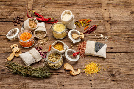 Zero waste food shopping concept. Cereals, pasta, legumes, dried mushrooms, spices. Sustainable lifestyle, old wooden boards background, copy spaceの写真素材