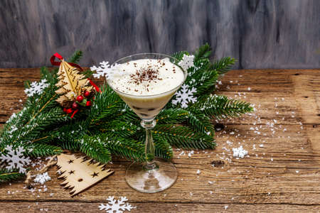 Traditional prune dessert with walnuts and whipped sour cream with sugar. New Year's sweet treat concept. Wooden boards background, copy spaceの写真素材