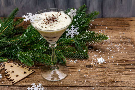 Traditional prune dessert with walnuts and whipped sour cream with sugar. New Year's sweet treat concept. Wooden boards background, copy spaceの写真素材
