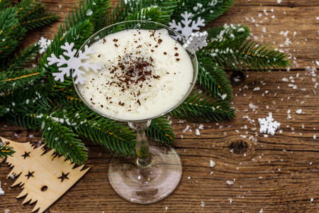 Traditional prune dessert with walnuts and whipped sour cream with sugar. New Year's sweet treat concept. Wooden boards background, top viewの写真素材