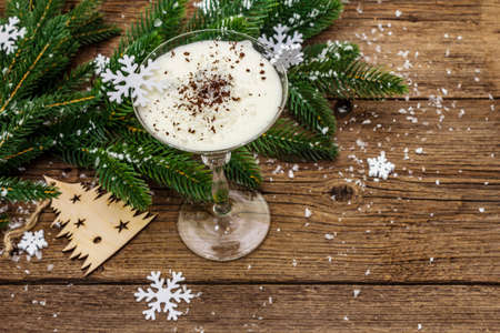 Traditional prune dessert with walnuts and whipped sour cream with sugar. New Year's sweet treat concept. Wooden boards background, top viewの写真素材