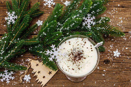 Traditional prune dessert with walnuts and whipped sour cream with sugar. New Year's sweet treat concept. Wooden boards background, top viewの写真素材