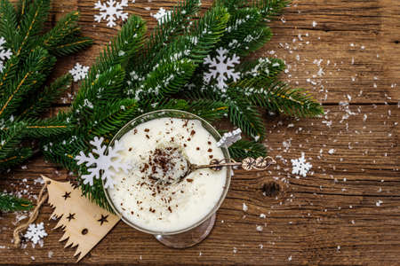 Traditional prune dessert with walnuts and whipped sour cream with sugar. New Year's sweet treat concept. Wooden boards background, top viewの写真素材