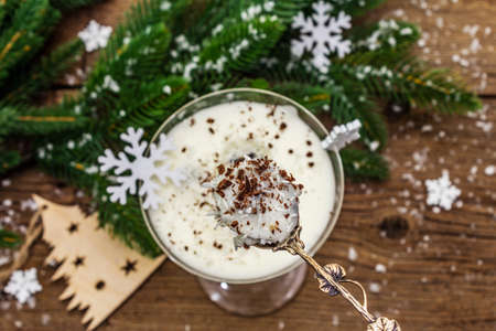 Traditional prune dessert with walnuts and whipped sour cream with sugar. New Year's sweet treat concept. Wooden boards background, top view, selective focusの写真素材