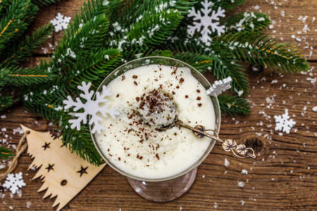 Traditional prune dessert with walnuts and whipped sour cream with sugar. New Year's sweet treat concept. Wooden boards background, top viewの写真素材