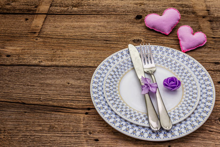 Romantic table setting on vintage wooden boards background. Valentine's day or Wedding card...