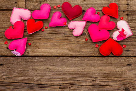 Valentines Day or Wedding background. Romantic and love emotion. Multicolored felt hearts on vintage wooden boards background, copy space, top viewの写真素材