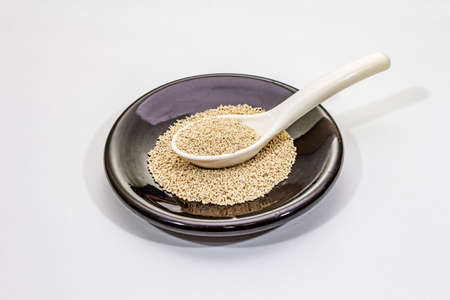 Dashi, traditional Japanese seasoning isolated on white background. Indispensable ingredient for cooking soup stock. Finished dry granules, close upの写真素材