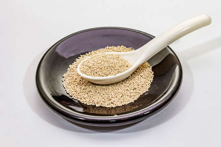 Dashi, traditional Japanese seasoning isolated on white background. Indispensable ingredient for cooking soup stock. Finished dry granules, close upの写真素材