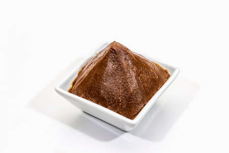Light brown miso paste isolated on white background. Traditional Japanese seasoning, indispensable ingredient for cooking soup stock, copy space, close upの写真素材