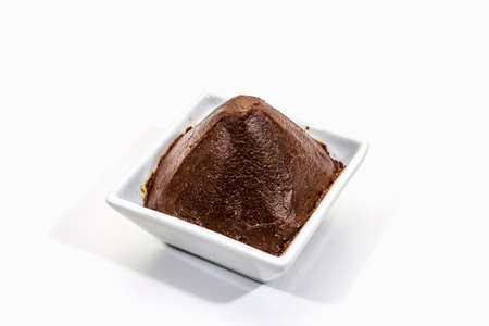 Dark brown miso paste isolated on white background. Traditional Japanese seasoning, indispensable ingredient for cooking soup stock, copy space, close upの写真素材