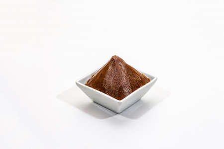 Light brown miso paste isolated on white background. Traditional Japanese seasoning, indispensable ingredient for cooking soup stock, copy space, close upの写真素材