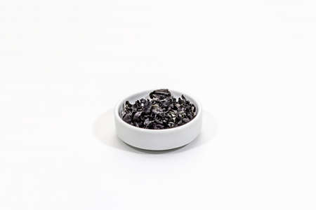 Dry wakame seaweed isolated on white background. Plate of dried kombu algae, traditional Japanese ingredient for cooking Dashi soup, copy spaceの写真素材