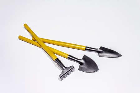 Garden tools isolated on white background. Plant care concept. Shovels and rakeの写真素材