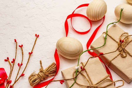 Zero waste Easter concept. Wooden eggs, gifts in craft paper. Not plastic, eco trend. White putty background, copy spaceの写真素材