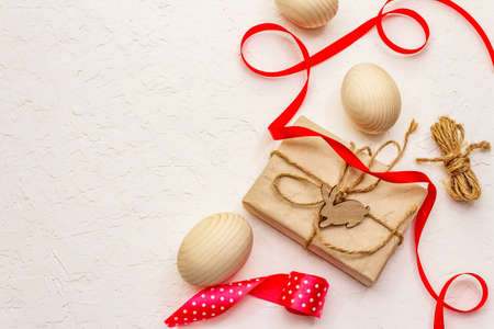 Zero waste Easter concept. Wooden eggs, gifts in craft paper. Not plastic, eco trend. White putty background, copy space, top viewの写真素材