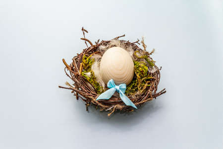 Easter bird nest. Zero waste, DIY concept. Soft feathers, moss. Light blue background, copy spaceの写真素材
