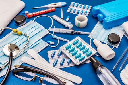 Set of diverse medical items. Means for the prevention, personal hygiene and treatment of the symptoms of coronavirus. COVID-19 pandemic, 2019-nCoV worldwide concept. Trendy blue color backgroundの写真素材