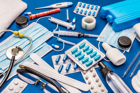 Set of diverse medical items. Means for the prevention, personal hygiene and treatment of the symptoms of coronavirus. COVID-19 pandemic, 2019-nCoV worldwide concept. Trendy blue color backgroundの写真素材