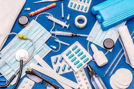 Set of diverse medical items. Means for the prevention, personal hygiene and treatment of the symptoms of coronavirus. COVID-19 pandemic, 2019-nCoV worldwide concept. Blue background, top viewの写真素材