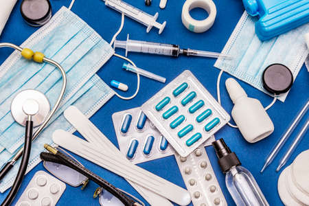 Set of diverse medical items. Means for the prevention, personal hygiene and treatment of the symptoms of coronavirus. COVID-19 pandemic, 2019-nCoV worldwide concept. Blue background, top viewの写真素材