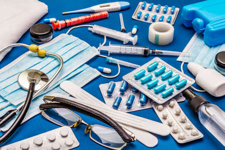 Set of diverse medical items. Means for the prevention, personal hygiene and treatment of the symptoms of coronavirus. COVID-19 pandemic, 2019-nCoV worldwide concept. Trendy blue color backgroundの写真素材