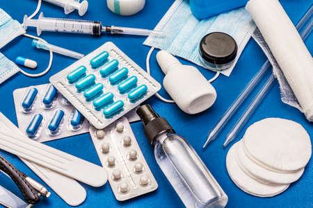 Set of diverse medical items. Means for the prevention, personal hygiene and treatment of the symptoms of coronavirus. COVID-19 pandemic, 2019-nCoV worldwide concept. Trendy blue color backgroundの写真素材
