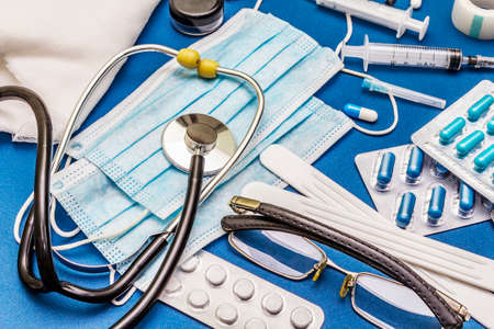 Set of diverse medical items. Means for the prevention, personal hygiene and treatment of the symptoms of coronavirus. COVID-19 pandemic, 2019-nCoV worldwide concept. Trendy blue color backgroundの写真素材