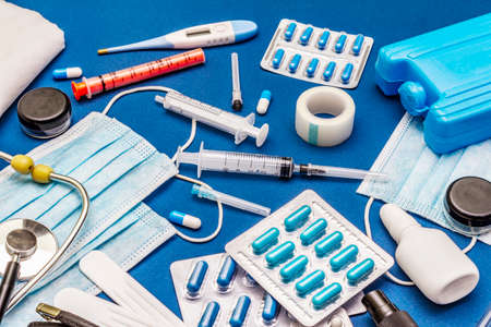Set of diverse medical items. Means for the prevention, personal hygiene and treatment of the symptoms of coronavirus. COVID-19 pandemic, 2019-nCoV worldwide concept. Trendy blue color backgroundの写真素材