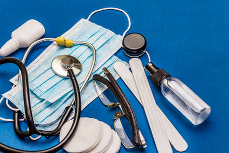 Set of diverse medical items. Means for the prevention, personal hygiene and treatment of the symptoms of coronavirus. COVID-19 pandemic, 2019-nCoV worldwide concept. Trendy blue color backgroundの写真素材