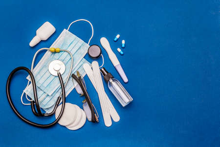 Set of diverse medical items. Means for the prevention, personal hygiene and treatment of the symptoms of coronavirus. COVID-19 pandemic, 2019-nCoV worldwide concept. Blue background, top viewの写真素材