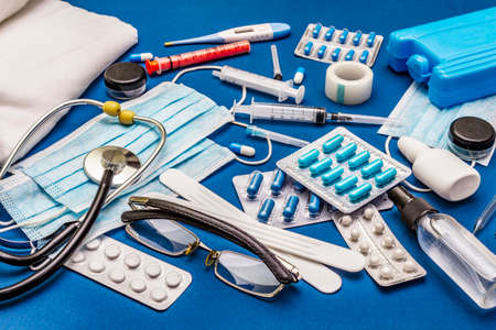 Set of diverse medical items. Means for the prevention, personal hygiene and treatment of the symptoms of coronavirus. COVID-19 pandemic, 2019-nCoV worldwide concept. Trendy blue color backgroundの写真素材