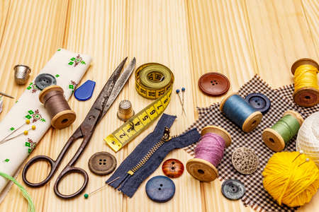 Handmade, DIY concept. Set of tools and materials for sewing. Stay at home in quarantine. Wooden boards backgroundの写真素材