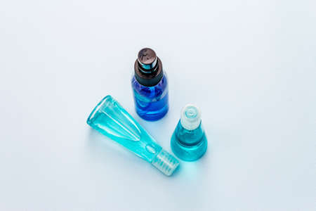 Sanitizer spray and gel isolated on blue background. Medical products for personal hygiene and the...