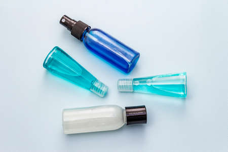 Sanitizer spray and gel isolated on blue background. Medical products for personal hygiene and the prevention of viral diseases. Coronavirus, COVID-19 pandemic, 2019-nCoV worldwide conceptの写真素材